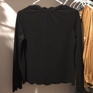 Long sleeve black top with scalloped ends